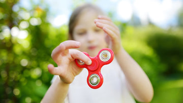 Best sensory toys - girl playing with fidget spinner