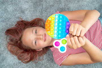 special needs girl playing with sensory toy